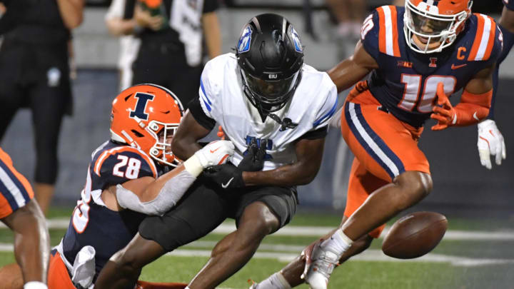 Aug 29, 2024; Champaign, Illinois, USA;  Illinois Fighting Illini linebacker Dylan Rosiek (28) srips the ball from Eastern Illinois Panthers wide receiver DeAirious Smith (6) during the second half at Memorial Stadium. Mandatory Credit: Ron Johnson-USA TODAY Sports