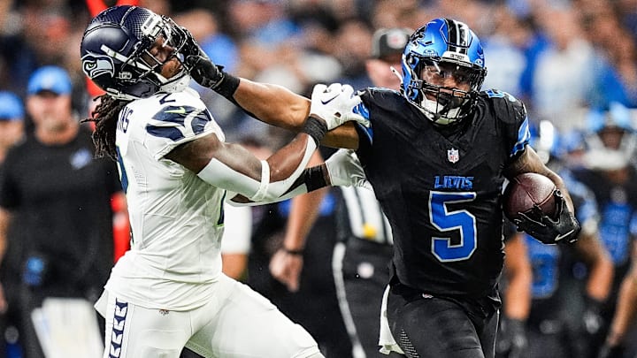 Detroit Lions running back David Montgomery defends against Seattle Seahawks safety Rayshawn Jenkins during a run.