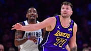 Feb 25, 2025; Los Angeles, California, USA; Los Angeles Lakers guard Luka Doncic (77) and Dallas Mavericks guard Kyrie Irving (11) attempt to gain control during the first quarter at Crypto.com Arena. Mandatory Credit: Gary A. Vasquez-Imagn Images