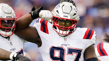 New England Patriots defensive end Milton Williams (97) celebrates sacking Tennessee Titans quarterback Cam Ward (1) during the third quarter at Nissan Stadium in Nashville, Tenn., Sunday, Oct. 19, 2025.