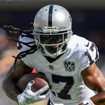 Sep 15, 2024; Baltimore, Maryland, USA; Las Vegas Raiders wide receiver Davante Adams (17) runs with the ball as Baltimore Ravens cornerback Marlon Humphrey (44) defends during the second half at M&T Bank Stadium. Mandatory Credit: Reggie Hildred-Imagn Images