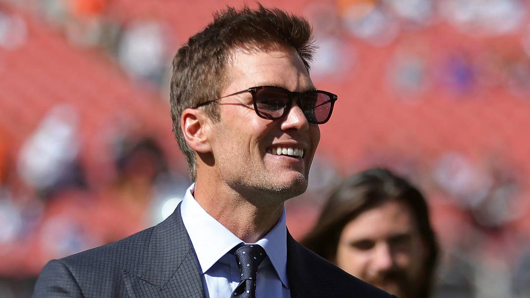 NFL legend Tom Brady is all smiles before an NFL football game at Huntington Bank Field, Sunday, Sept. 8, 2024, in Cleveland, Ohio.