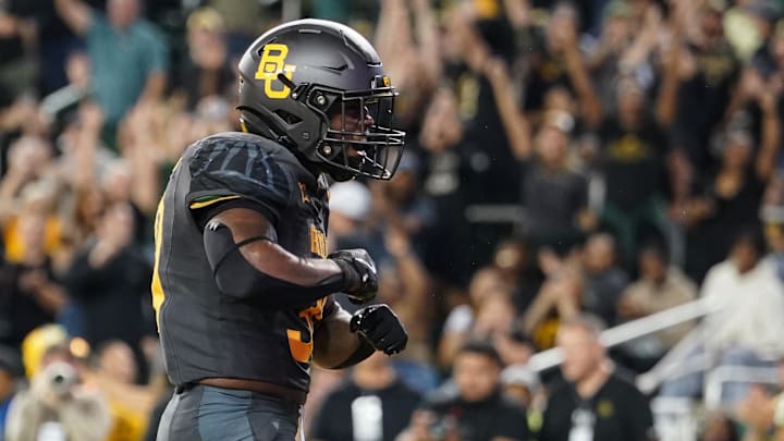 Nov 2, 2024; Waco, Texas, USA;  Baylor Bears running back Bryson Washington (30) celebrates after scoring a touchdown against the TCU Horned Frogs during the first half at McLane Stadium. Mandatory Credit: Chris Jones-Imagn Images