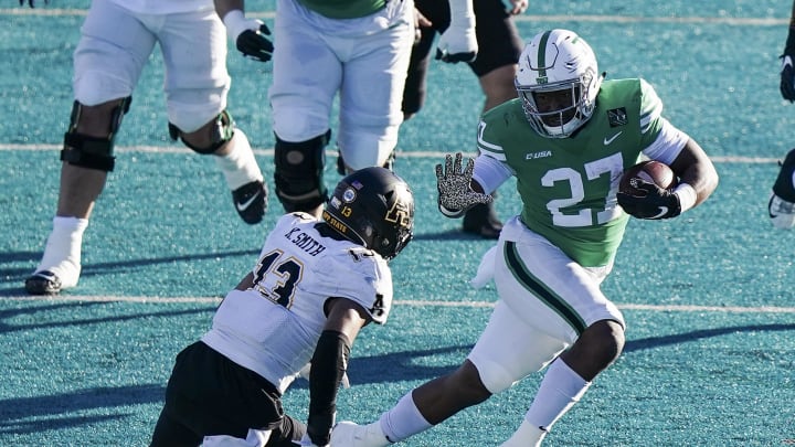 Dec 21, 2020; Conway, SC, USA;  North Texas Mean Green running back Oscar Adaway III  (27 )avoids Appalachian State Mountaineers defensive back Kaiden Smith (13) in the second quarter at Brooks Stadium. Mandatory Credit: David Yeazell-USA TODAY Sports