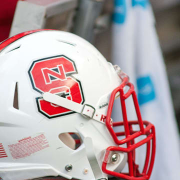 Sep 5, 2015; Raleigh, NC, USA; A North Carolina State Wolfpack helmet lays on the field during the first half against the Troy Trojans at Carter Finley Stadium. North Carolina State defeated Troy 49-21. Mandatory Credit: Jeremy Brevard-Imagn Images
