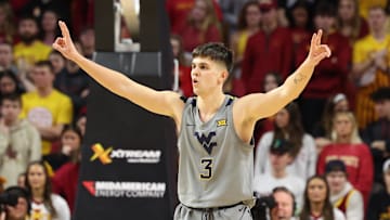 Feb 24, 2024; Ames, Iowa, USA; West Virginia Mountaineers guard Kerr Kriisa (3) celebrates after a