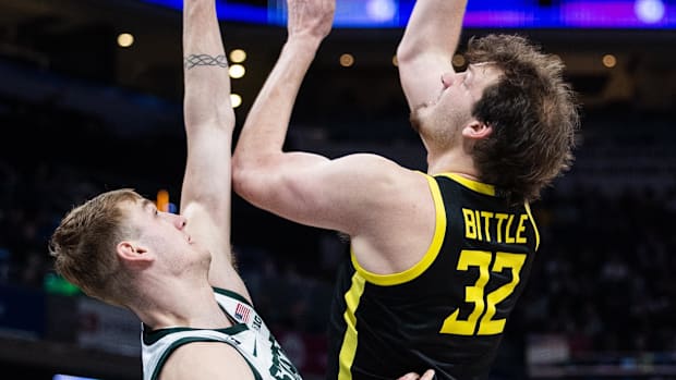 Oregon Ducks center Nate Bittle (32) shoots the ball while Michigan State Spartans center Carson Cooper (15) defends