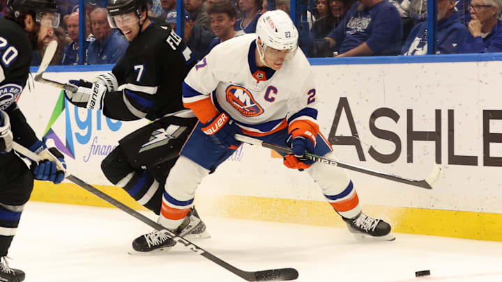 Mar 30, 2024; Tampa, Florida, USA; Tampa Bay Lightning defenseman Haydn Fleury (7) and left wing Nicholas Paul (20) defends New York Islanders left wing Anders Lee (27)  during the second period at Amalie Arena. Mandatory Credit: Kim Klement Neitzel-USA TODAY Sports