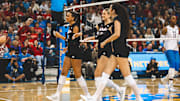 Nebraska players celebrate a point at UCLA Friday night. The Huskers lost a set for the first time in Big Ten play, but remained undefeated.