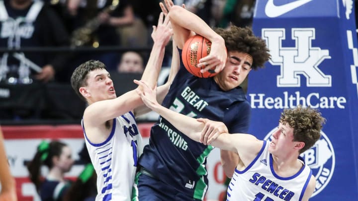 Great Crossing's Malachi Moreno (24), center, gets double-teamed by Spencer County's Keaton Baird (10), left, and Spencer County's Andrew Barron (13) in the second half in the first round of the 2024 UK Healthcare KHSAA Boys' Sweet 16 in Lexington. March 20, 2024