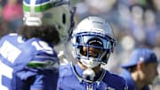 Oct 5, 2025; Seattle, Washington, USA; Seattle Seahawks wide receiver Jaxon Smith-Njigba (11) and wide receiver Tory Horton (15) warm up prior to a game against the Tampa Bay Buccaneers at Lumen Field. 