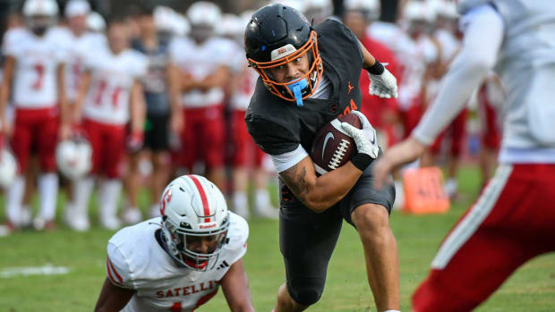 Jayvan Boggs of Cocoa tries to maneuver through the Satellite defense in the 2023 season opening football kickoff classic 