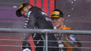 Oct 22, 2023; Austin, Texas, USA; Mercedes AMG Petronas Motorsport driver Lewis Hamilton (44) of Team Great Britain and McLaren F1 driver Lando Norris (4) of Team Great Britain celebrates with champagne after the 2023 United States Grand Prix at Circuit of the Americas. Mandatory Credit: Jerome Miron-USA TODAY Sports