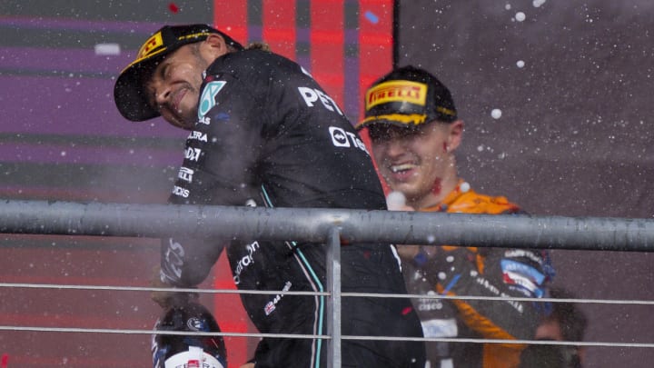 Oct 22, 2023; Austin, Texas, USA; Mercedes AMG Petronas Motorsport driver Lewis Hamilton (44) of Team Great Britain and McLaren F1 driver Lando Norris (4) of Team Great Britain celebrates with champagne after the 2023 United States Grand Prix at Circuit of the Americas. Mandatory Credit: Jerome Miron-USA TODAY Sports