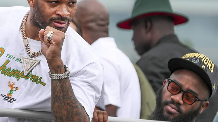 Milwaukee Bucks forward P.J. Tucker (17) holds up a fist as the crowd cheers during the Bucks victory parade on July 22, 2021.