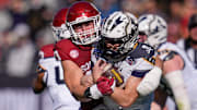 Oklahoma Sooners defensive lineman Ethan Downs (40) brings down Navy Midshipmen quarterback Blake Horvath (11) during the Armed Forces Bowl football game between the University of Oklahoma Sooners (OU) and the Navy Midshipmen at Amon G. Carter Stadium in Fort Worth, Texas, Friday, Dec. 27, 2024.