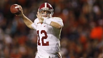 Nov 27, 2009; Auburn, AL, USA; Alabama quarterback Greg McElroy (12) scrambles out of the pocket to pass against the Auburn Tigers during the 4th quarter of the 74th annual iron bowl at Jordan-Hare Stadium. Alabama defeated Auburn 26-21.  Mandatory Credit: John David Mercer-Imagn Images