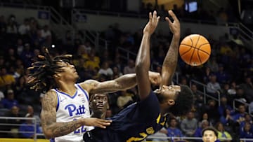Nov 11, 2022; Pittsburgh, Pennsylvania, USA;  Pittsburgh Panthers guard Nike Sibande (22) fouls West Virginia Mountaineers guard Kobe Johnson (2) during the second half at the Petersen Events Center. West Virginia won 81-56. Mandatory Credit: Charles LeClaire-Imagn Images