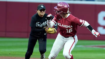 Oklahoma's Abby Dayton (16) gets caught in a run down as UCF's Samantha Rey (2) chases her in the second inning of the college softball game between the University of Oklahoma Sooners and the UCF Knights at Love's Field in Norman, Okla., Friday, April, 4, 2025.