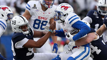 Dec 21, 2024; University Park, Pennsylvania, USA; Southern Methodist Mustangs running back Brashard Smith (1) runs with the ball while trying to avoid a tackle during the fourth quarter against the Penn State Nittany Lions in the first round of the College Football Playoff at Beaver Stadium. Mandatory Credit: Matthew O'Haren-Imagn Images