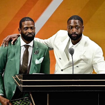 Aug 12, 2023; Springfield, MA, USA;  Dwyane Wade (right) calls his father Dwyane Wade Sr. (left) onto the stage at his induction into the 2023 Basketball Hall of Fame at Symphony Hall. Mandatory Credit: Eric Canha-Imagn Images
