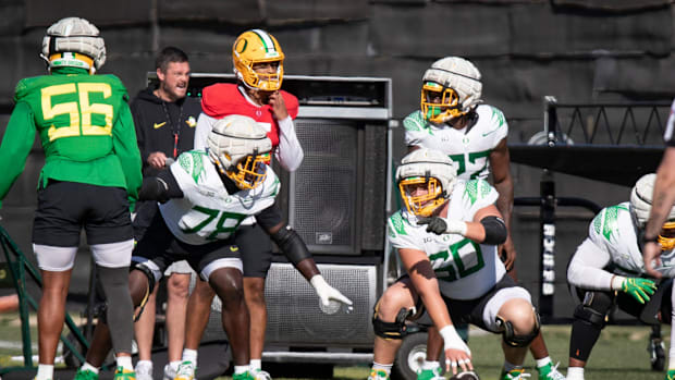 Oregon lineman Kanen Rossi lines up as center with quarterback Dante Moore during practice with the Oregon Ducks Wednesday, A
