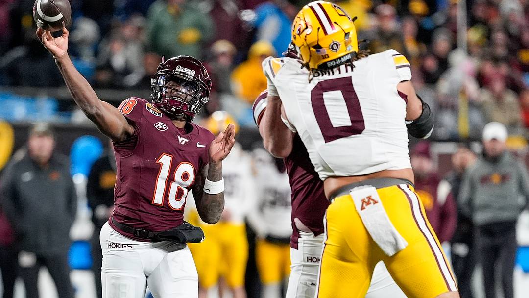 Jan 3, 2025; Charlotte, NC, USA; Virginia Tech Hokies quarterback William Watson III (18) makes a throw over Minnesota Golden Gophers defensive lineman Anthony Smith (0) during the second half at the Duke’s Mayo Bowl at Bank of America Stadium. Mandatory Credit: Jim Dedmon-Imagn Images