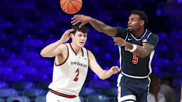 Nov 27, 2024; Paradise Island, Bahamas, BHS; Arizona Wildcats guard KJ Lewis (5) passes around Davidson Wildcats forward Bobby Durkin (2) during the first half at the Atlantis Resort.  Mandatory Credit: Kevin Jairaj-Imagn Images