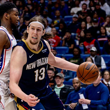 Mar 24, 2025; New Orleans, Louisiana, USA;  New Orleans Pelicans forward Kelly Olynyk (13) dribbles against Philadelphia 76ers forward Justin Edwards (19) during the second half at Smoothie King Center. Mandatory Credit: Stephen Lew-Imagn Images
