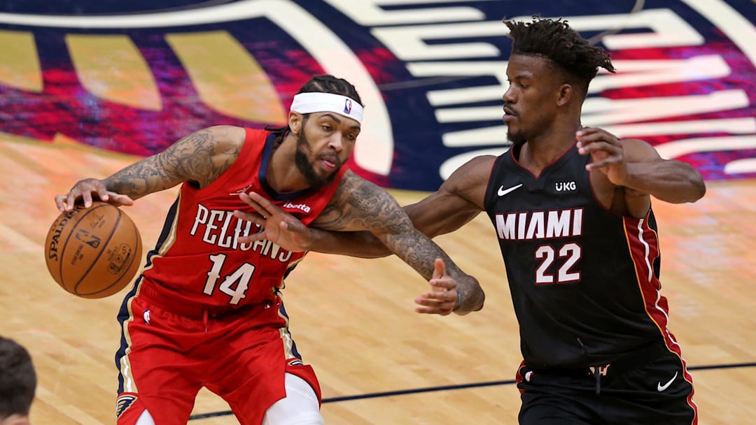 Mar 4, 2021; New Orleans, Louisiana, USA; New Orleans Pelicans forward Brandon Ingram (14) is defended by Miami Heat forward Jimmy Butler (22) in the fourth quarter at the Smoothie King Center. 