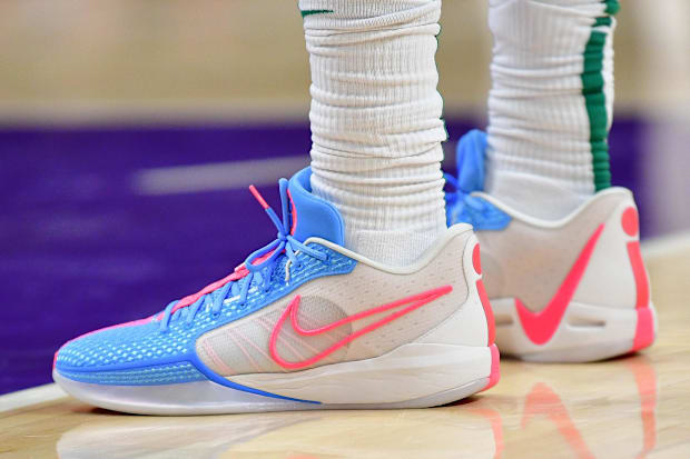 Boston Celtics guard Jrue Holiday's white and blue Nike sneakers.