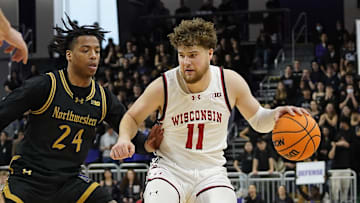 Feb 1, 2025; Evanston, Illinois, USA; Northwestern Wildcats guard K.J. Windham (24) defends Wisconsin Badgers guard Max Klesmit (11) during the first half at Welsh-Ryan Arena. Mandatory Credit: David Banks-Imagn Images