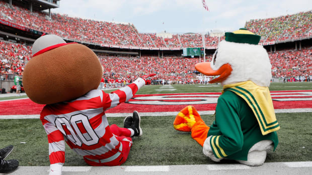 Two mascots sit next to each other.