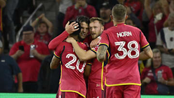 Sep 28, 2024; St. Louis, Missouri, USA; St. Louis CITY SC midfielder Eduard Loewen (10) is congratulated after scoring a goal against the Sporting Kansas City in the second half at CITYPARK. Mandatory Credit: Joe Puetz-Imagn Images