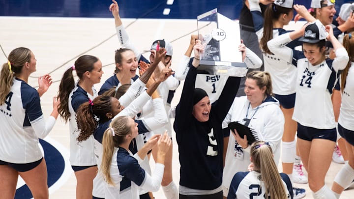 Penn State women's volleyball head coach Katie Schumacher-Cawley holds up the Big Ten title trophy after the Nittany Lions defeated Nebraska 3-1 to claim at least a share of the title. 
