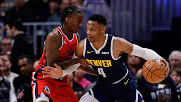 Dec 13, 2024; Denver, Colorado, USA; Denver Nuggets guard Russell Westbrook (4) controls the ball as Los Angeles Clippers guard Bones Hyland (5) guards in the second quarter at Ball Arena. Mandatory Credit: Isaiah J. Downing-Imagn Images