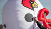 Kevin Brierly attached an inflated Louisville football helmet to his truck while tailgating before