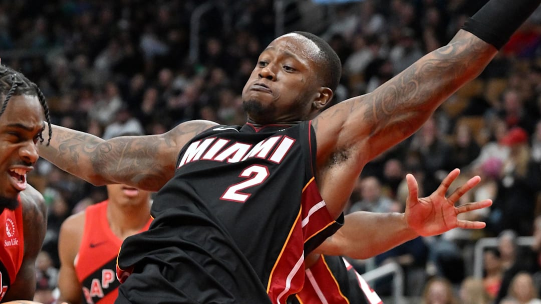 Dec 1, 2024; Toronto, Ontario, CAN;  Toronto Raptors guard Davion Mitchell (45) drives toward the basket against Miami Heat guard Terry Rozier III (2) in the second half at Scotiabank Arena. Mandatory Credit: Dan Hamilton-Imagn Images