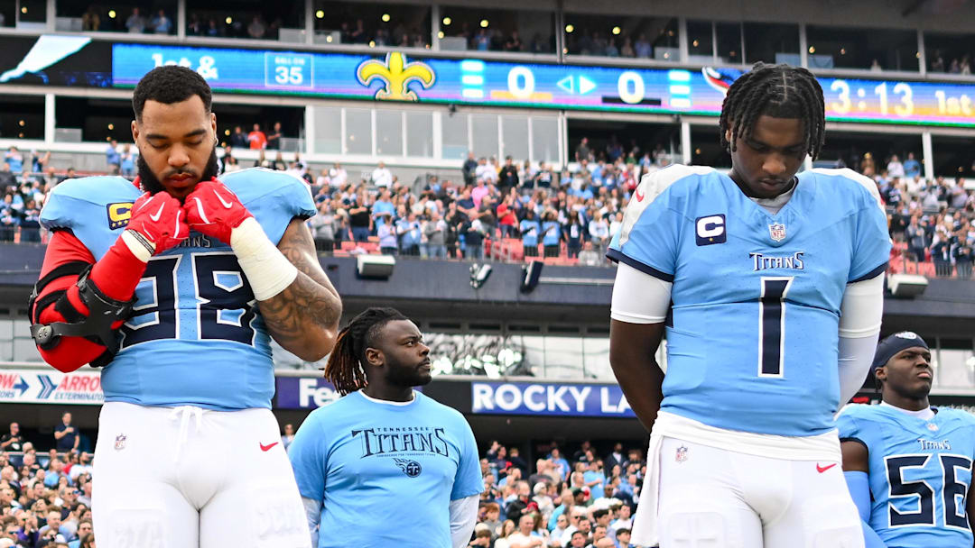 Dec 28, 2025; Nashville, Tennessee, USA;  Tennessee Titans defensive tackle Jeffery Simmons (98) and quarterback Cameron Ward (1) stand during the National Anthem against the New Orleans Saints during the first half at Nissan Stadium. Mandatory Credit: Steve Roberts-Imagn Images