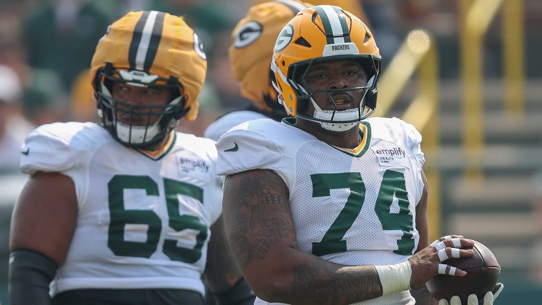 Green Bay Packers center Elgton Jenkins (74) catches a ball between practice reps on Thursday, July 31, 2025, at Ray Nitschke Field in Ashwaubenon, Wis. 