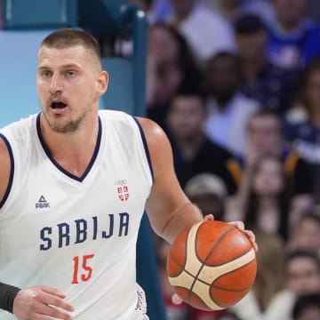 Jul 28, 2024; Villeneuve-d'Ascq, France; Serbia power forward Nikola Jokic (15) dribbles in the fourth quarter against the United States during the Paris 2024 Olympic Summer Games at Stade Pierre-Mauroy. 