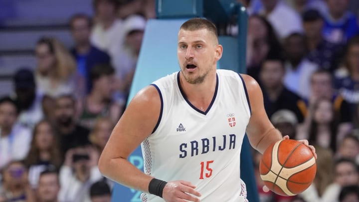 Jul 28, 2024; Villeneuve-d'Ascq, France; Serbia power forward Nikola Jokic (15) dribbles in the fourth quarter against the United States during the Paris 2024 Olympic Summer Games at Stade Pierre-Mauroy. 