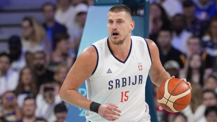 Jul 28, 2024; Villeneuve-d'Ascq, France; Serbia power forward Nikola Jokic (15) dribbles in the fourth quarter against the United States during the Paris 2024 Olympic Summer Games at Stade Pierre-Mauroy. Mandatory Credit: John David Mercer-USA TODAY Sports