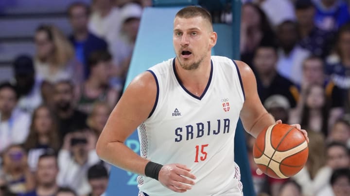 Jul 28, 2024; Villeneuve-d'Ascq, France; Serbia power forward Nikola Jokic (15) dribbles in the fourth quarter against the United States during the Paris 2024 Olympic Summer Games at Stade Pierre-Mauroy. Mandatory Credit: John David Mercer-USA TODAY Sports