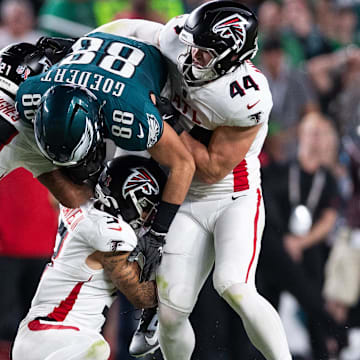 Sep 16, 2024; Philadelphia, Pennsylvania, USA; Philadelphia Eagles tight end Dallas Goedert (88) is tackled by Atlanta Falcons linebacker Troy Andersen (44) and cornerback Mike Hughes (21) after a catch during the second quarter at Lincoln Financial Field. Mandatory Credit: Bill Streicher-Imagn Images