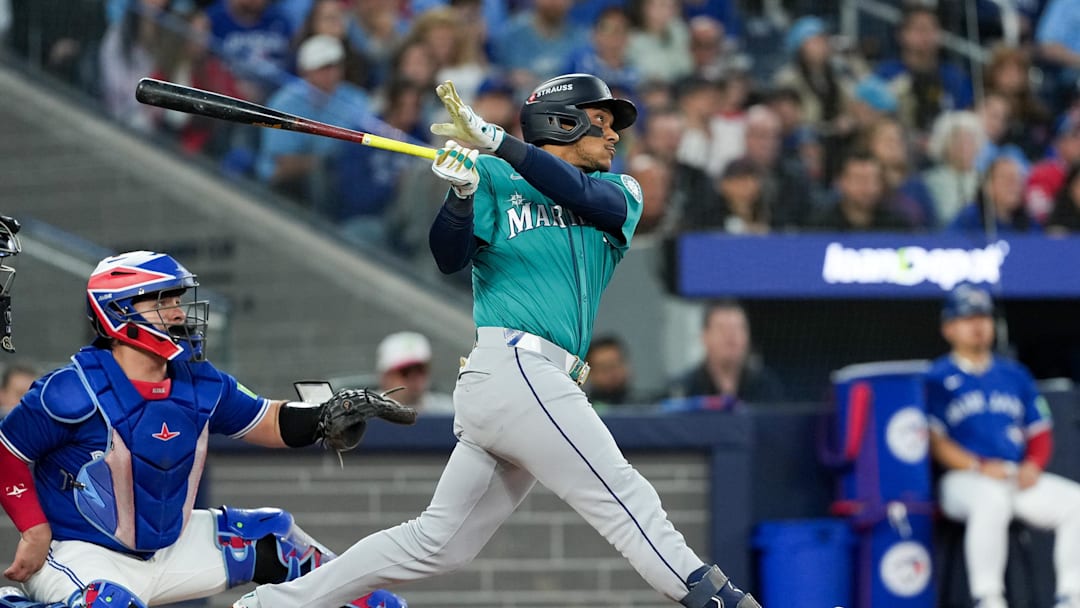 Oct 13, 2025; Toronto, Ontario, CAN; Seattle Mariners infielder Jorge Polanco (7) hits a three run home run in the fifth inning against the Toronto Blue Jays during game two of the ALCS round for the 2025 MLB playoffs at Rogers Centre. Mandatory Credit: Nick Turchiaro-Imagn Images