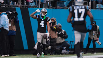 Nov 30, 2025; Charlotte, North Carolina, USA; Carolina Panthers wide receiver Tetairoa McMillan (4) celebrates after scoring a touchdown during the fourth quarter against the Los Angeles Rams at Bank of America Stadium.