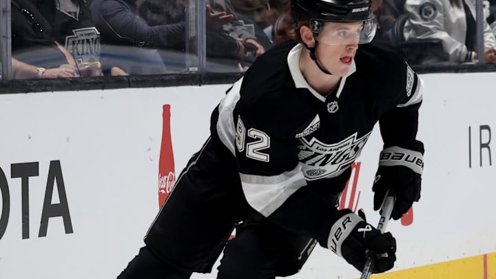 Oct 24, 2024; Los Angeles, California, USA; Los Angeles Kings defenseman Brandt Clarke (92) skates with the puck during the first period against the San Jose Sharks at Crypto.com Arena. Mandatory Credit: Jason Parkhurst-Imagn Images