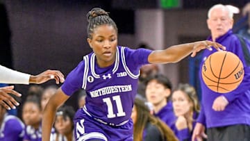 Nov 15, 2023; South Bend, Indiana, USA; Northwestern Wildcats guard Hailey Weaver (11) dribbles as Notre Dame Fighting Irish guard KK Bransford (14) defends in the second half at the Purcell Pavilion.