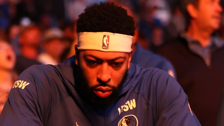 Anthony Davis sits on the bench before a match against the Warriors